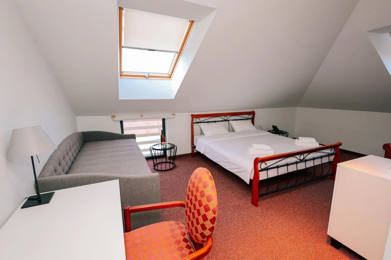 Double Room with a skylight over a writing desk, a sofa and a king bed